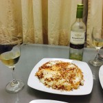 persian rice dish on table with wine
