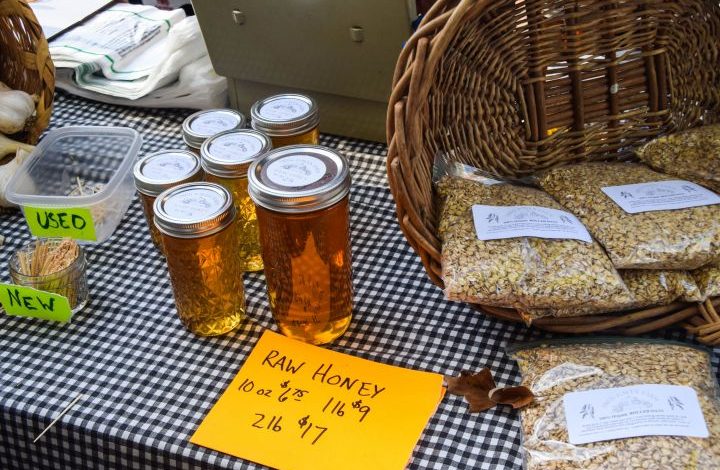 Honey and oats for sale on a farmers market table