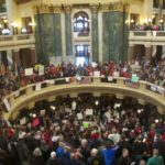Photo of the WI Capitol Rotunda filled with protestors. Photo from dividedwefall-movie.com